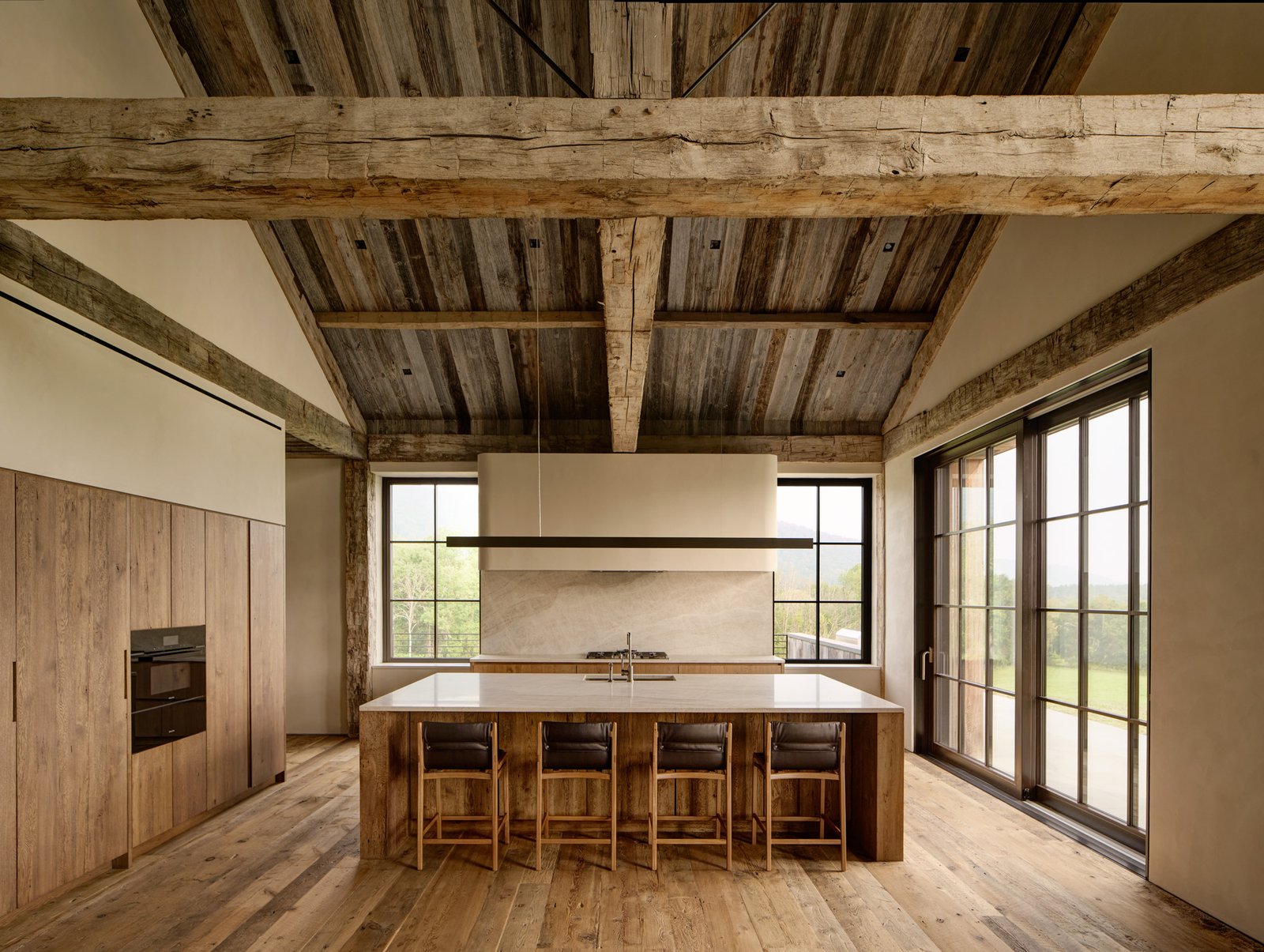 Kitchen in modern post and beam high ceilings big windows 